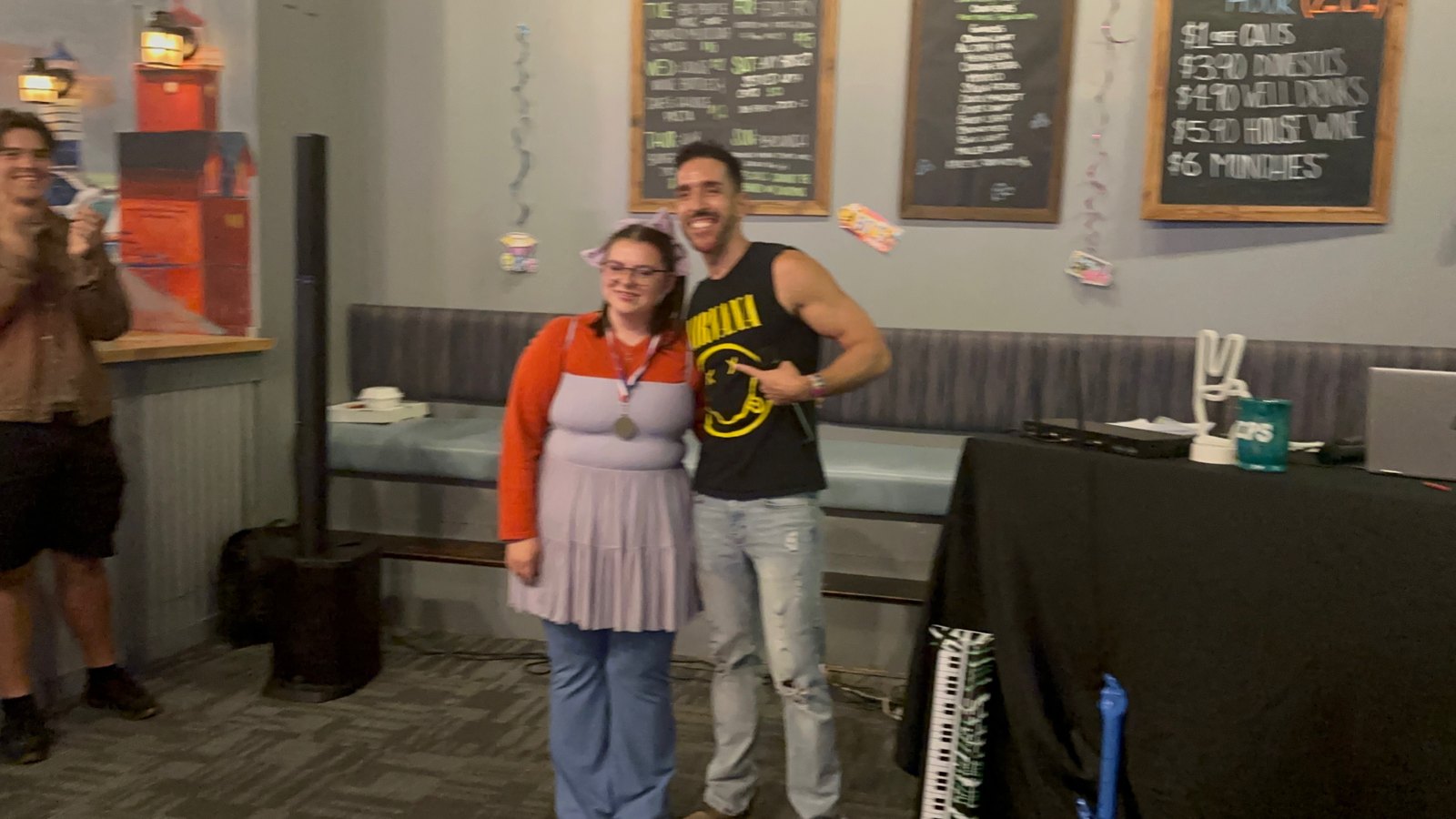 Friends posing together at a themed karaoke night